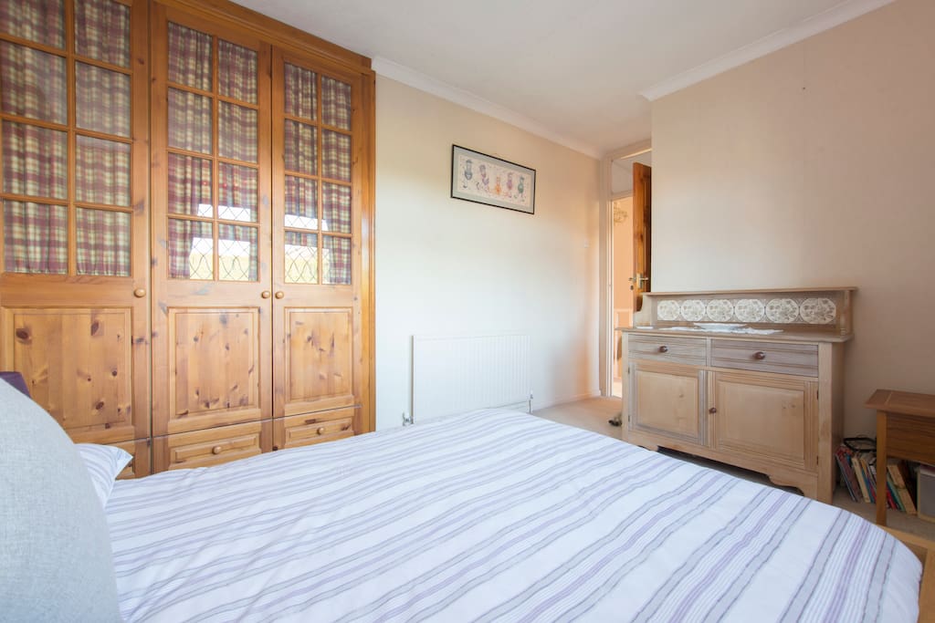Spacious double bedroom with fitted wardrobe and chest of drawers