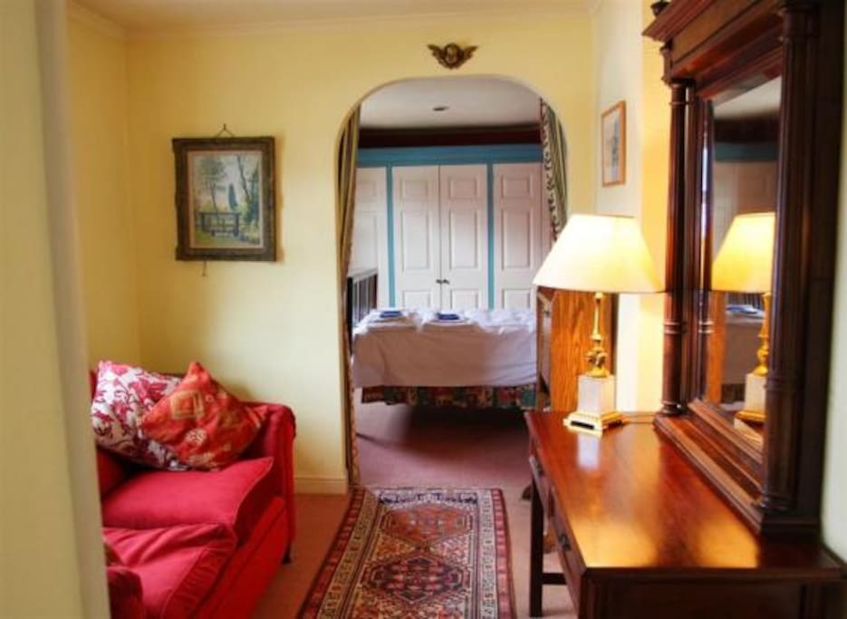 The dressing area from the bedroom with a sofa bed.