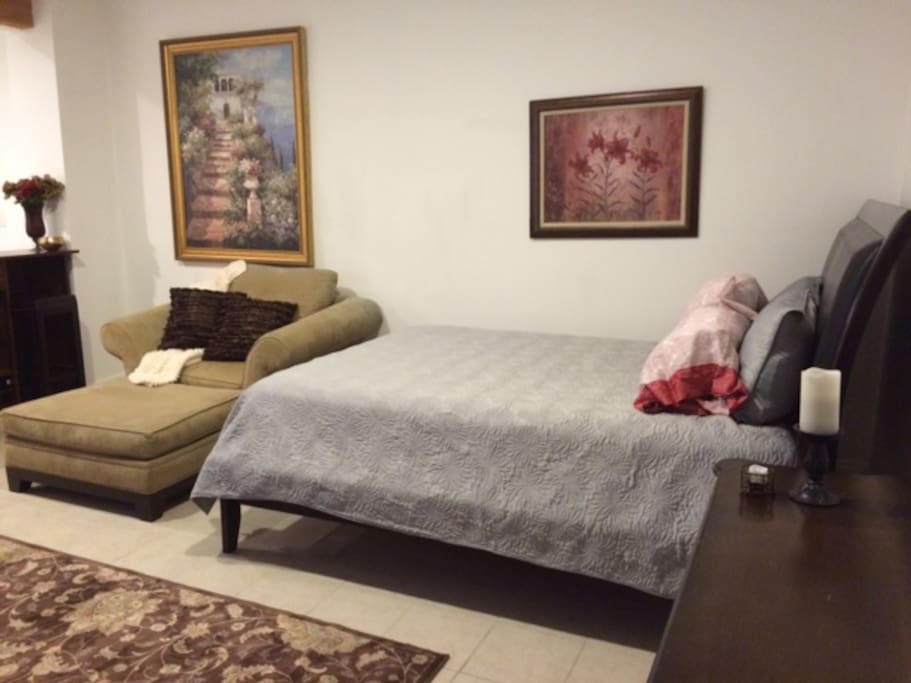 Comfortable queen size bed, plush lounger and mini bar.