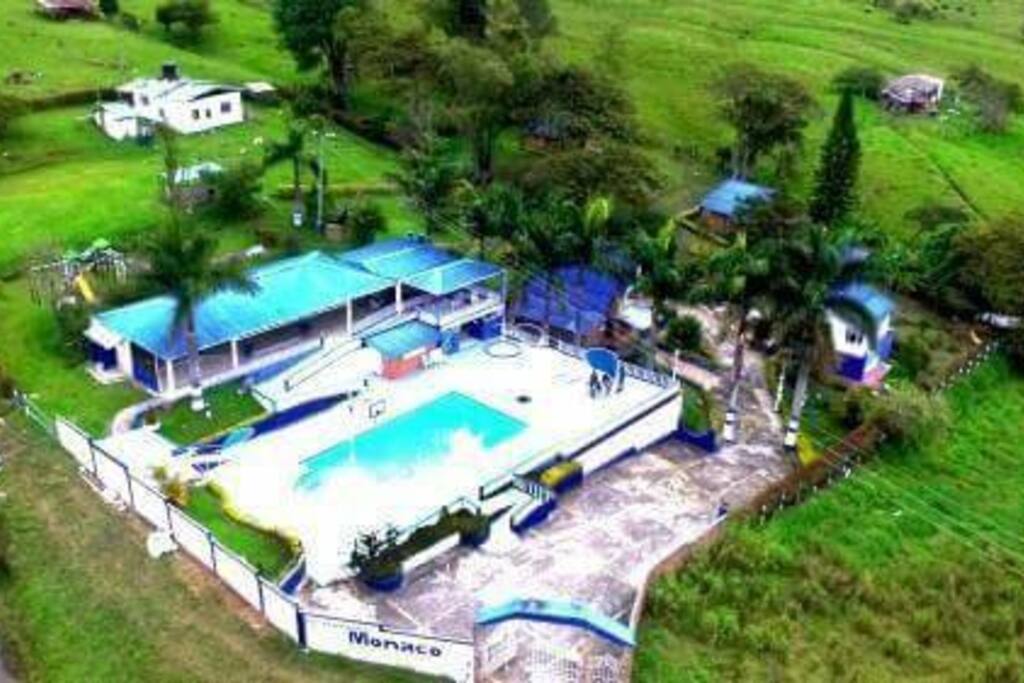 CENTRO RECREACIONAL MONACO CONTACTO 3123004450
CARACTERISTICAS:
Lote de terreno de aproximadamente 1.7 hectáreas en terreno plano descendente, dos lagos de pesca deportiva . A 3 kms del casco urbano de moniquira por vía pavimentada.
- Piscina
- Salón social
- Baños y duchas para la piscina
- Bar piscina
- Sauna piscina
- Área de hamacas
- Zona social para piscina
- Balcón
- Área de BBQ ( cocina, comedor, parrilla, horno)
- Parque infantil
- Parqueaderos
- Portada
- Zona de camping
- Parrillero para llanera
- 4 cabañas
CABAÑA PRINCIPAL 2 NIVELES
- Alojamiento para veinte personas
- Cocina
- Comedor
- Sala
- Baños
CABAÑA AUXILIAR
- alojamiento cómodo para diez personas
- baños
2 CABAÑAS GEMELAS PARA OCHO PERSONAS CADA UNA
- 2 habitaciones
- Baño
- Cocina
- Parrilla
- Corredor
Casa de seguridad privada
- 2 habitaciones
- Baño
- Cocina
- Deposito