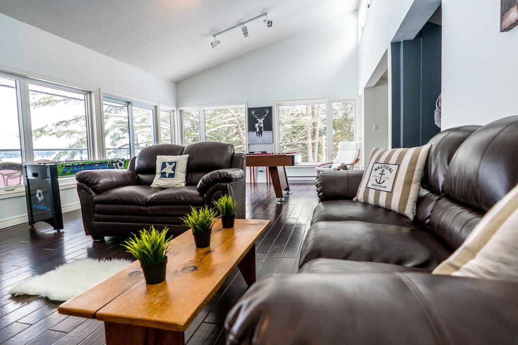 The Great Room has it all: space for everyone to unwind, 65" TV, stereo, pool table, foosball, DVDs, books, and the most spectacular views of Sparrow Lake!