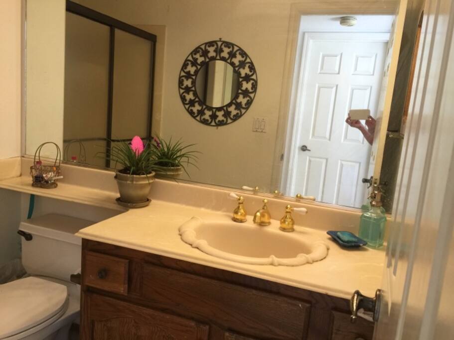 Spacious bathroom with basic necessities with fast-acting hot shower.