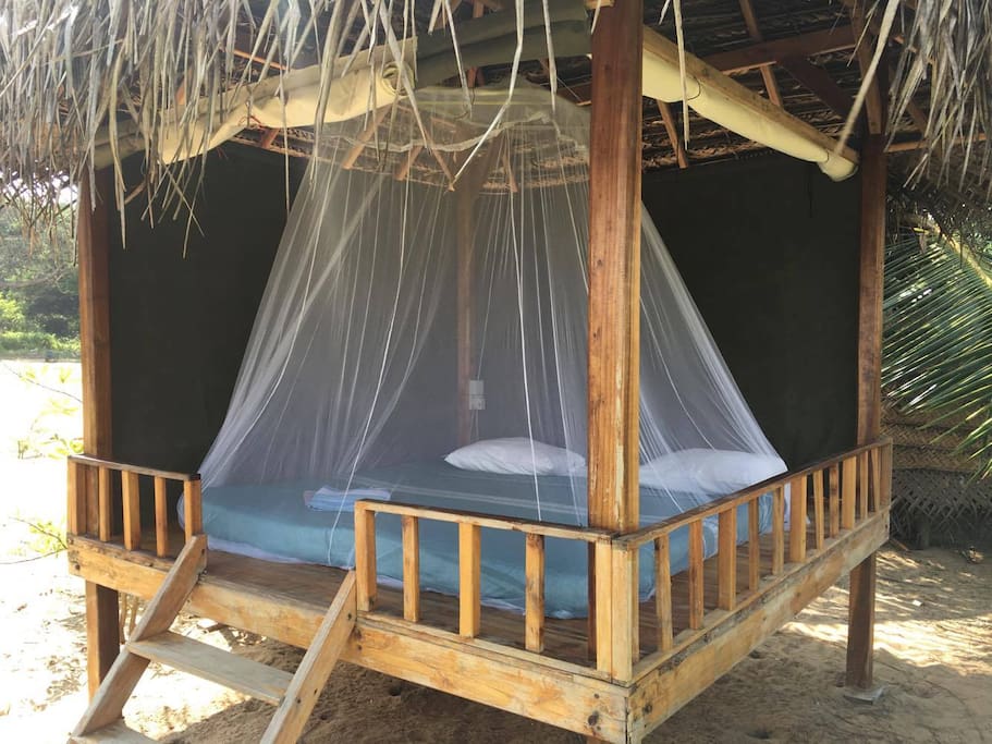 The bed and mosquito net in the kiosk
