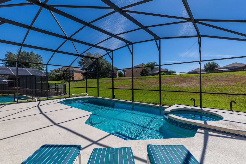 This extended pool deck soaks in the Florida sunshine - but the screened enclosure keeps out the bugs for comfortable sunbathing all day long.