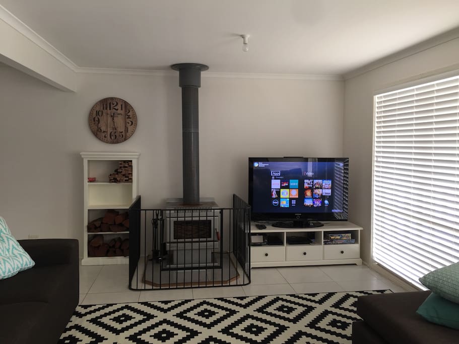 Open plan living area with woodfire heater