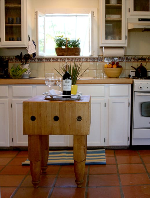 Kitchen is stocked with cooking utensils, keurig coffee maker and teas.
