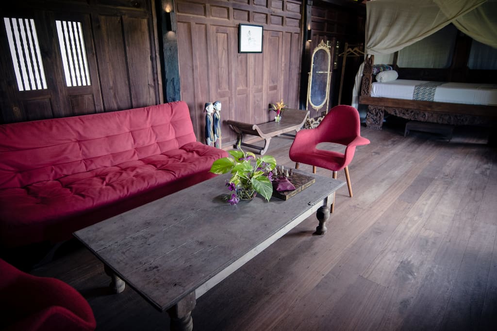 Master Bedroom with queen size bed in a four poster wooden bed frame and comfy sofa