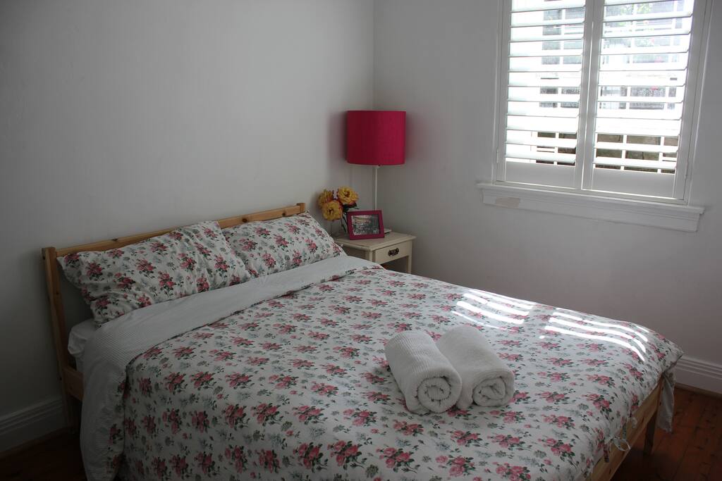 Spacious bedroom with fitted wardrobe, and plantation shutters