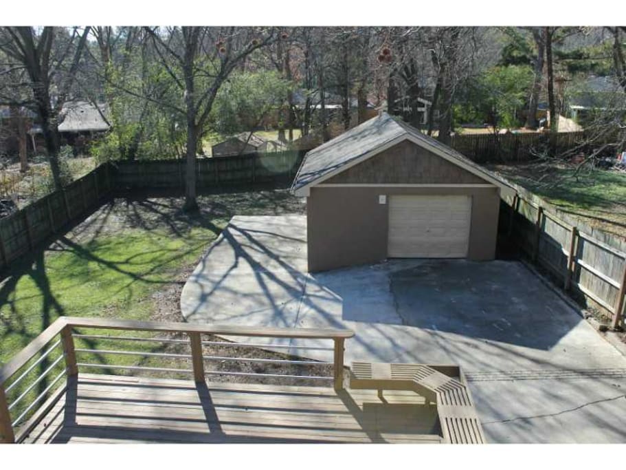 Fenced back yard with large deck and additional parking