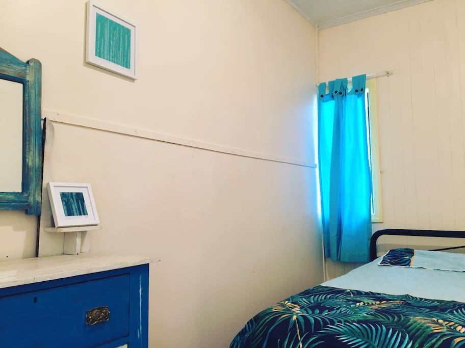 Bedroom two with two single beds and a duchess.