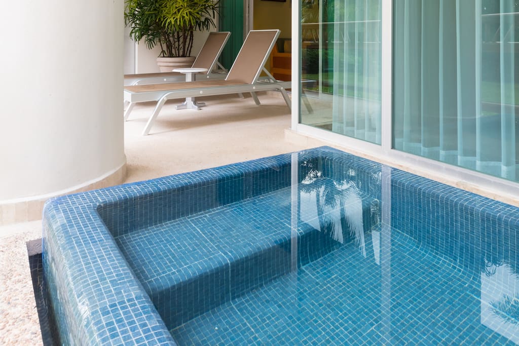 A balcony with private plunge pool and views of the beach and jungle.