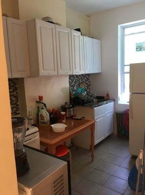 Furnished kitchen with stove and refrigerator