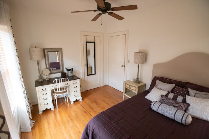 The second bedrooms has a queen bed with a writing desk and a closet.