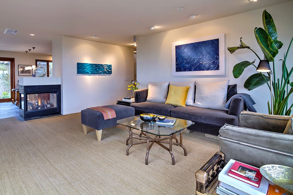 Lounge on the stylish living room furniture next to a double-sided gas fireplace.