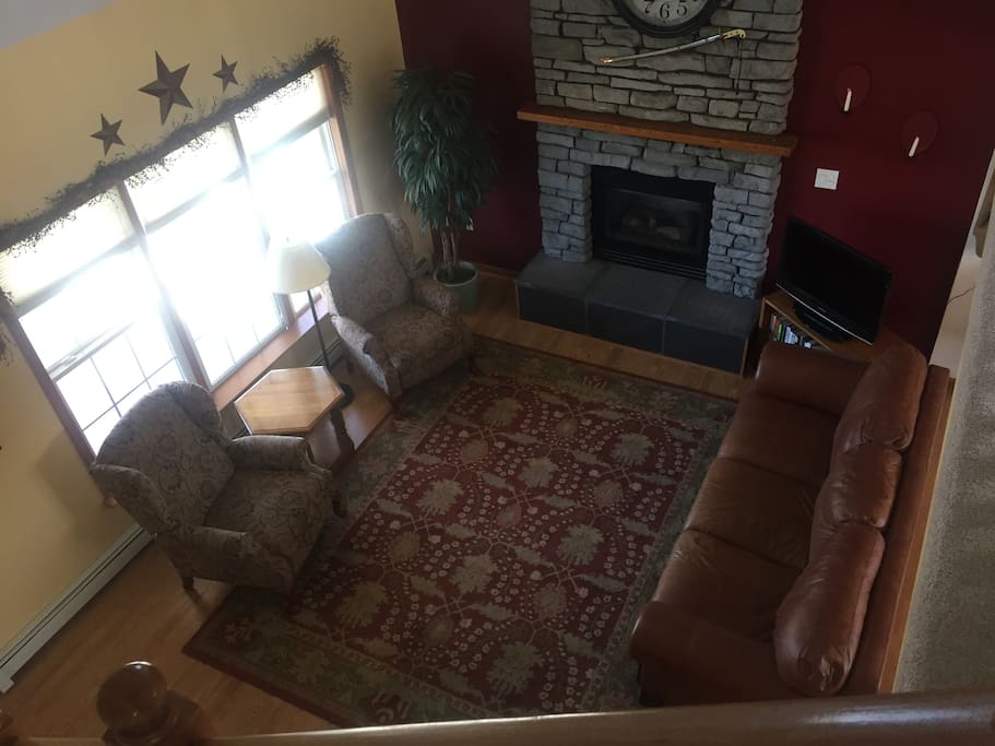 Vaulted ceiling looking down from landing at living room with fireplace