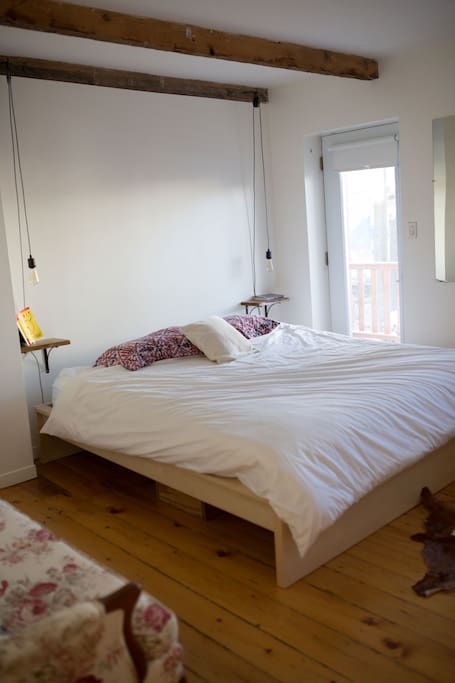 Large master bedroom with king bed and private balcony