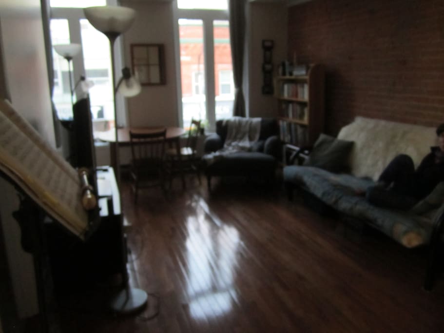 Brick wall in living room! Big windows! Comfy space!
