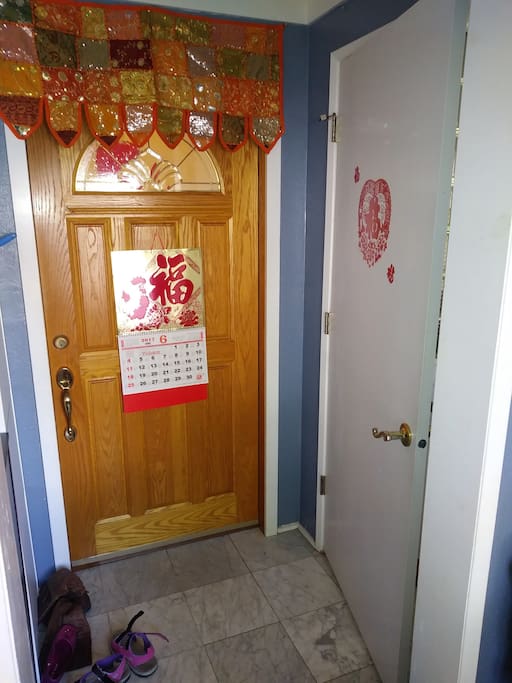 The white door on the right is the entrance to the AirBnB guest rooms and living space. Wooden door is entrance to our living air. Separate locks.