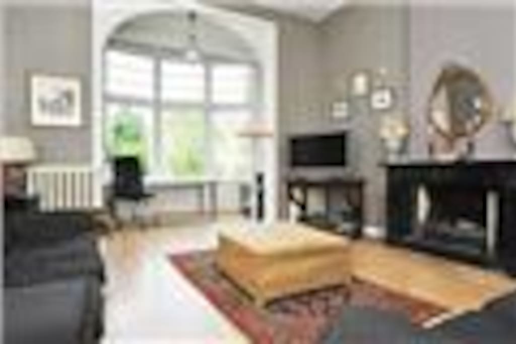 Large room with fireplace and tv, nespresso machine, water cooker etc.