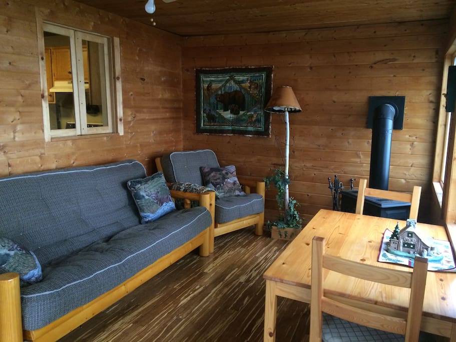 Best room of the house, the four-season porch overlooks the lake. Cozy up to the gas fireplace with your favorite book. Futon folds out for additional guests.