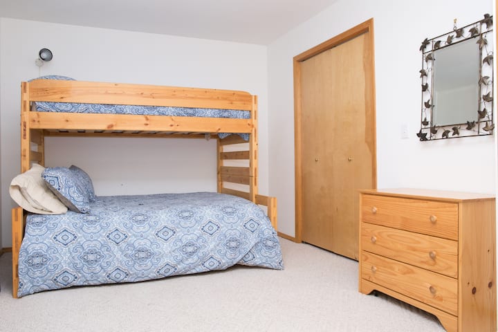 First bedroom on lower floor.  Double doors open to a spacious bedroom with twin over full bunk.  Full closet and set of drawers.  Nice box window give great lighting, curtains to darken for sleep.