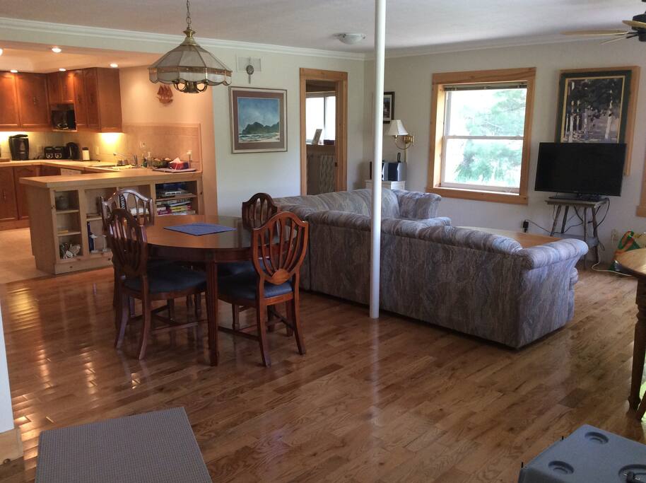 Large open concept living with over-sized windows, hardwood floors and natural light.