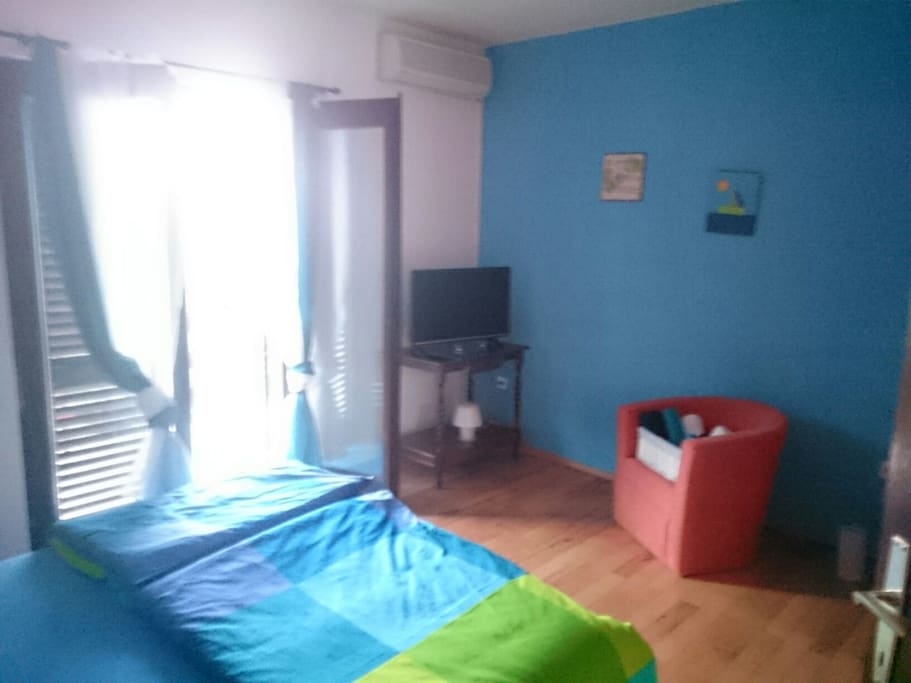 Big air conditioned bedroom with the TV and exit on the terrace with a lovely view on the channel and a lighthouse