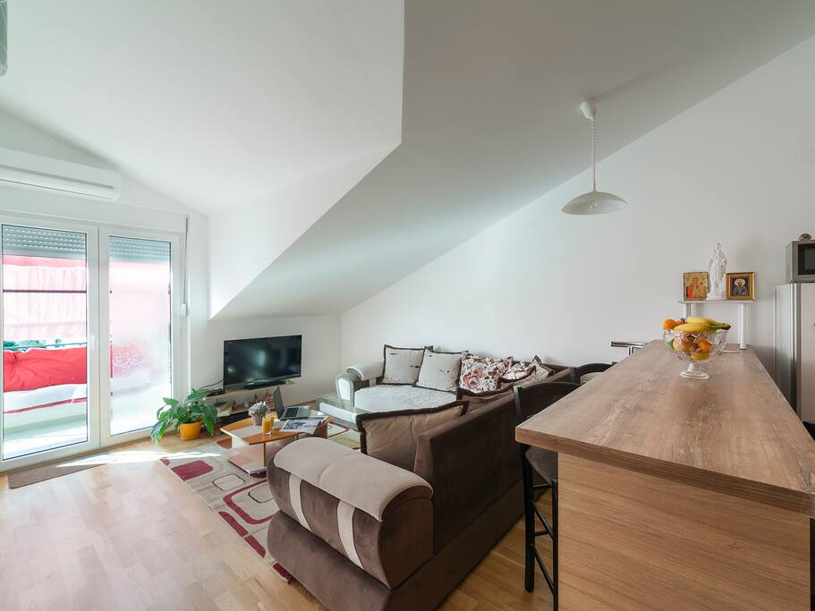 this is a comfortable living room, illuminated and pleasant, overlooking the city and the balcony, guests spend the most time here, very comfortable and provided for a real holiday.