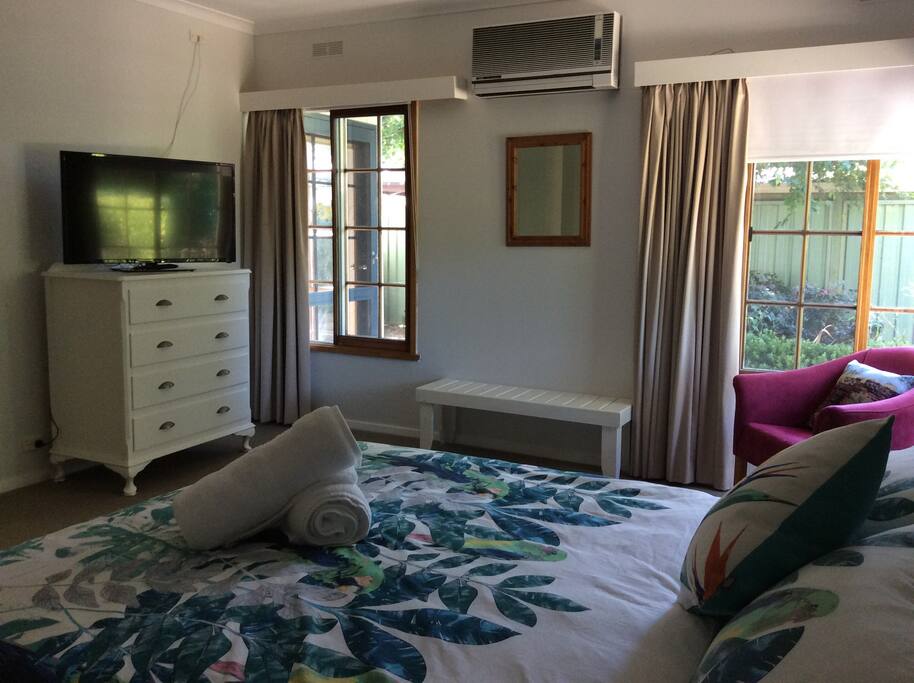 Large room with Queen size bed reverse cycle air conditioner and TV
