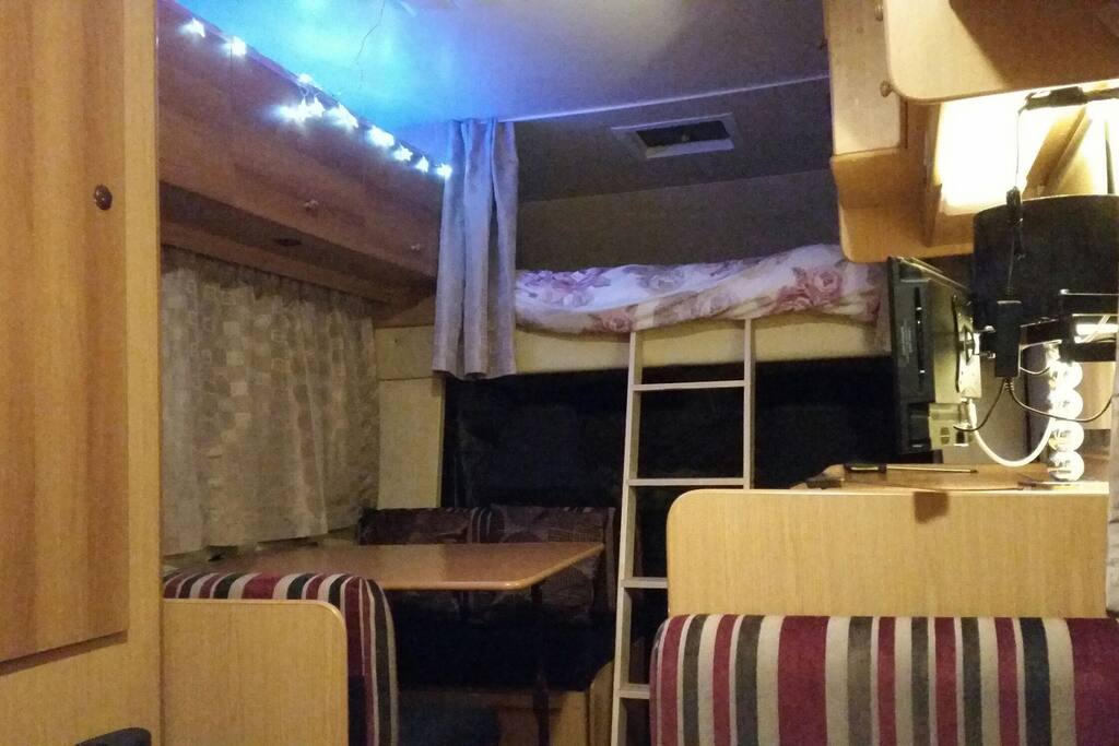 Overview of the front. King size bed on top with sturdy ladder access with its own privacy curtains.