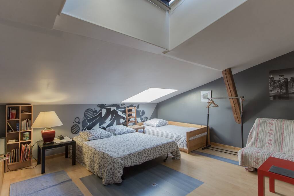 Une chambre spacieuse avec 2 lits d'1 personne, 1 lit 2 personnes et un futon