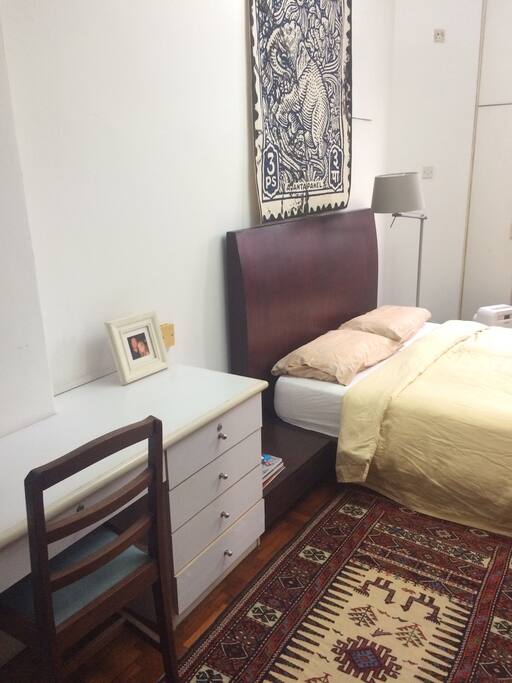 Room has a small desk with drawers