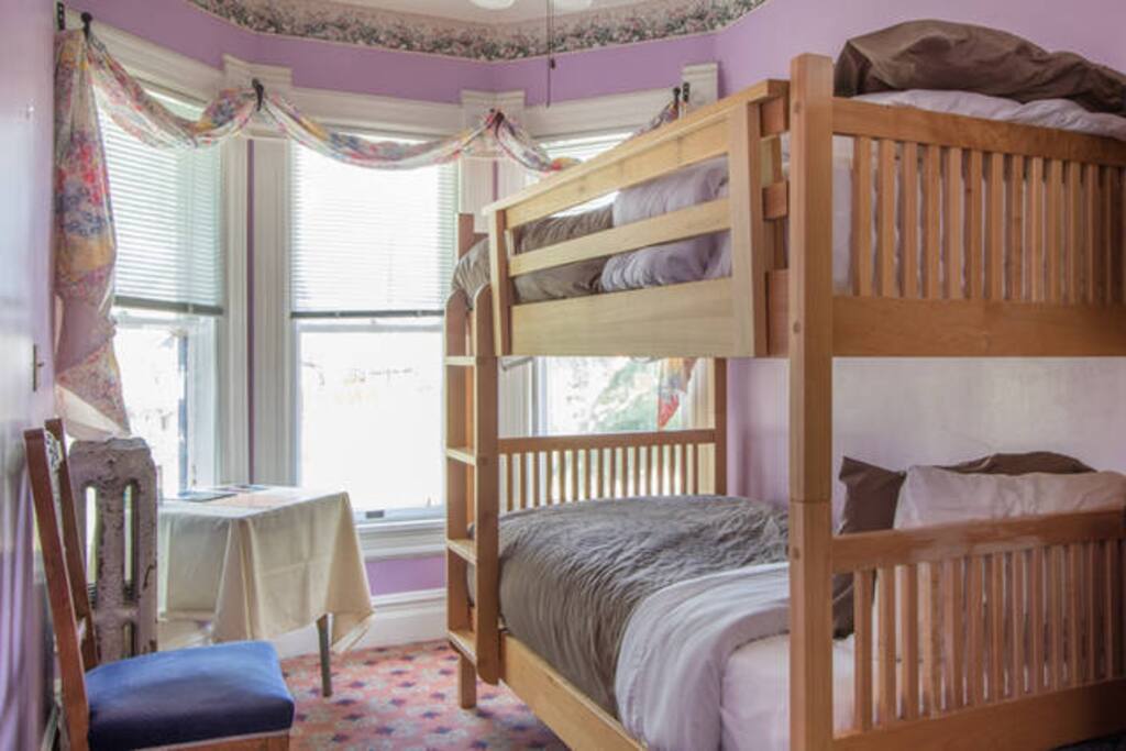The second room has a bunk bed with a turret window looking out over 8th street.