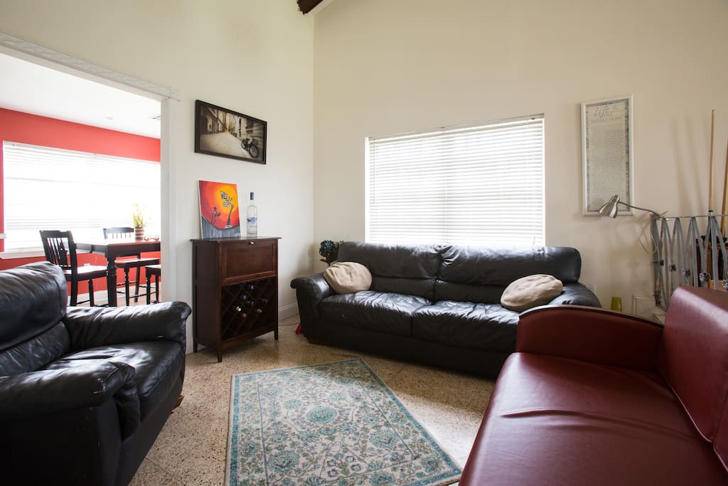 This space is great for relaxing and chatting about your day in the big easy . The brick color love seat is a pullout .
