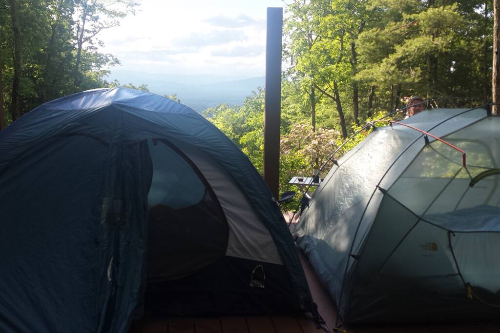 Two tents set up on upper tier.