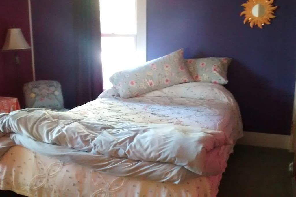 This room has north and west facing windows with a big ol' friendly sequoia tree right outside the window! There is a queen size bed, two bedroom chairs, small table and bench for luggage.