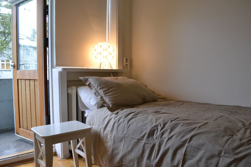 The other bedroom is smaller with a twin bed and it opens out to a small balcony.