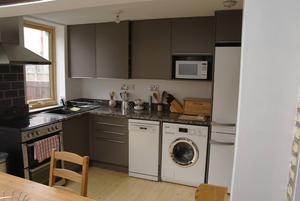 Fully equipped kitchn with French doors to mature garden