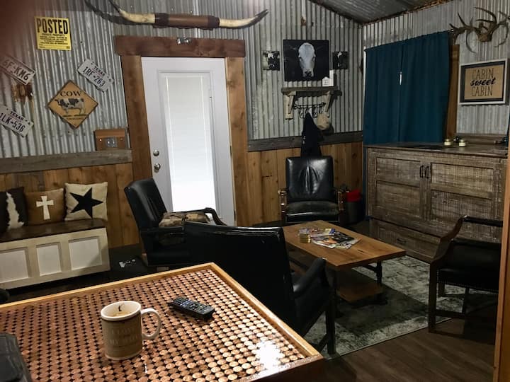 The rustic barn feel surrounds you in this entertaining space.  No couch, just chairs.  If you desire to lay around, the firm queen bed is just pulled out for you to do just that!