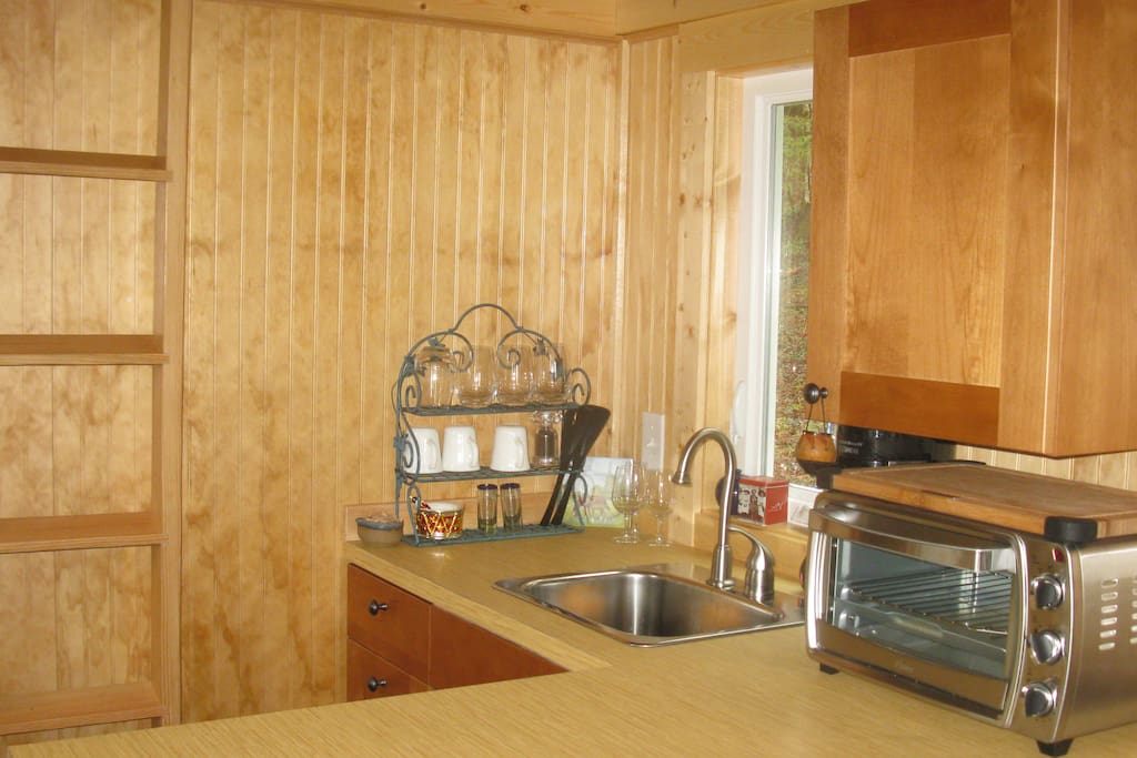 Kitchen has small oven, refrig and 2-burner convection stove.