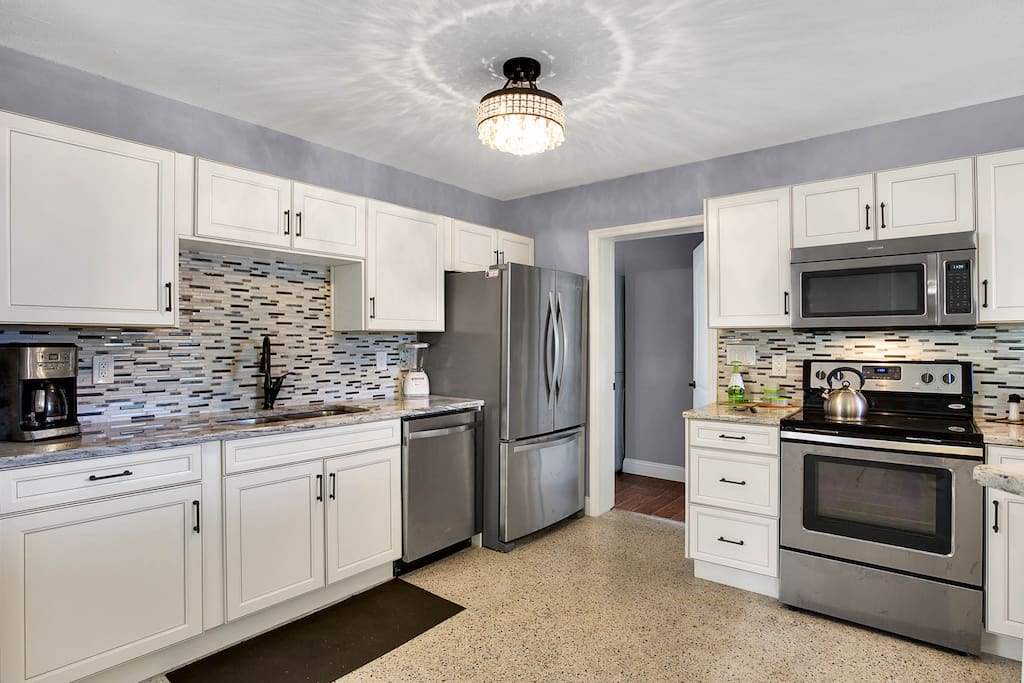The spacious kitchen with tiled back splash.