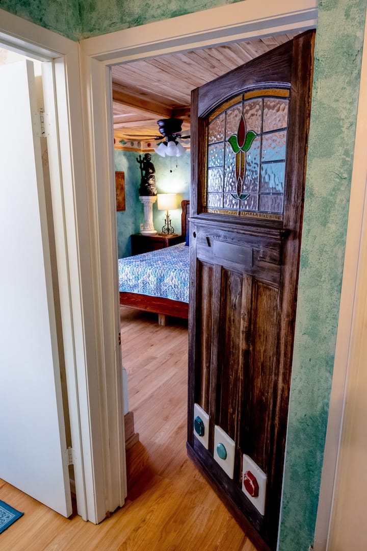 View from hallway- to the left is the restroom. Past the wooden door leads to the bedroom 