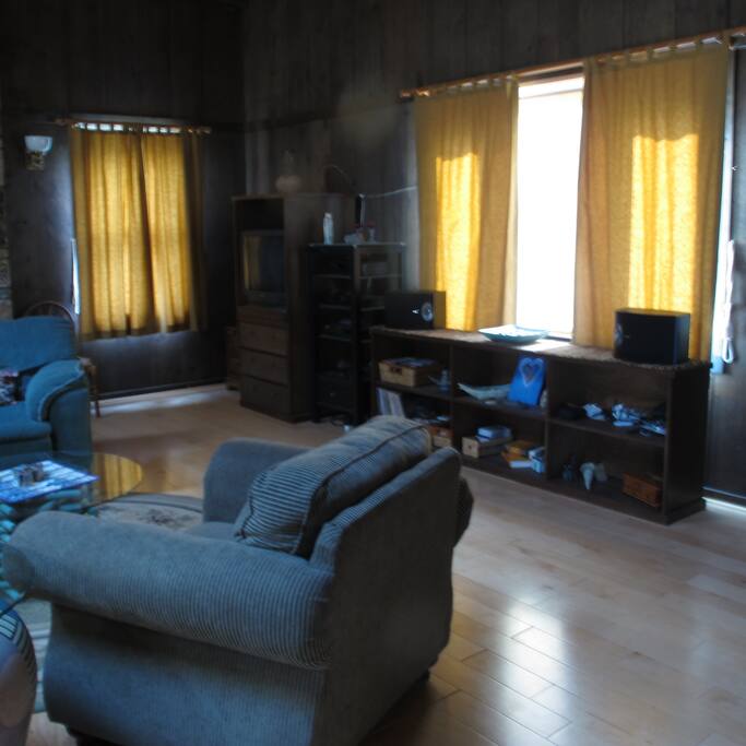 More living room with bay window opening to gazebo area