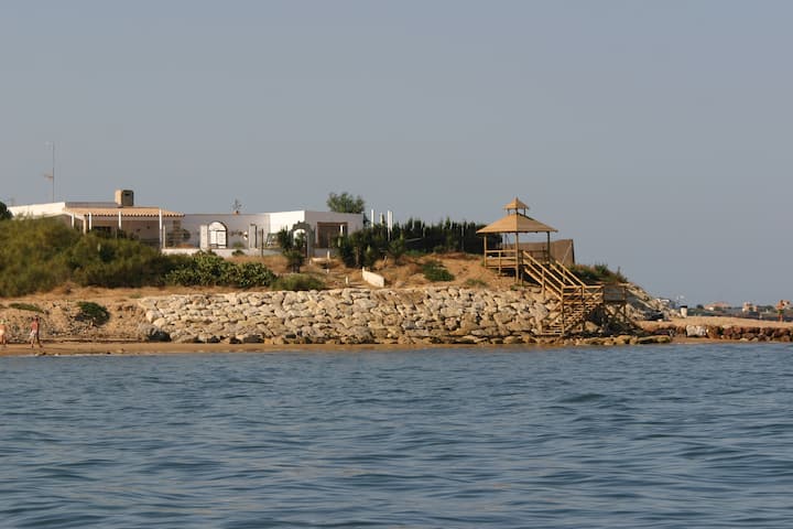 Beachfront chalet surrounded by the sea. Pool.