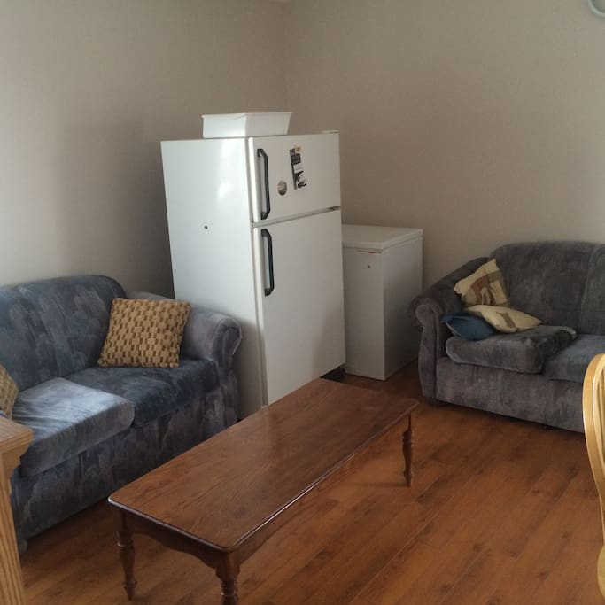 Living room connected to kitchen, open concept.