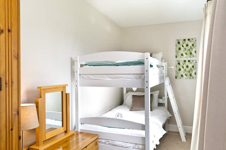 First of five bedrooms, this one is situated on the ground floor, next door to the downstairs shower room. Bunkbeds, single wardrobe and set of drawers. Tastefully decorated.
Bedding and towels are provided or your arrival.