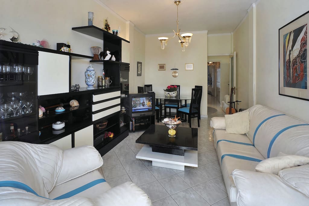 Living room with a spacious dinning table that sets 8
