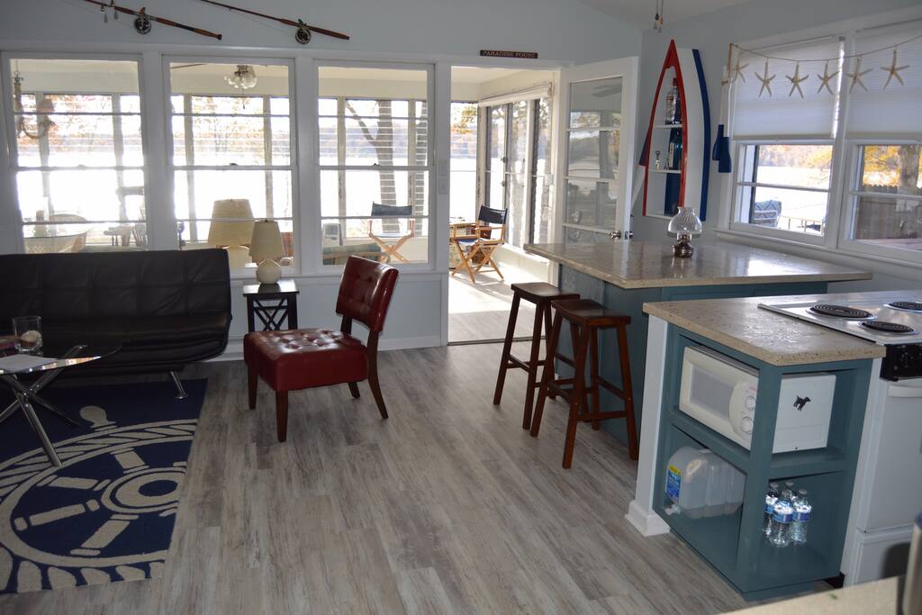 Main room with rolling eating space and stools and views of the creek