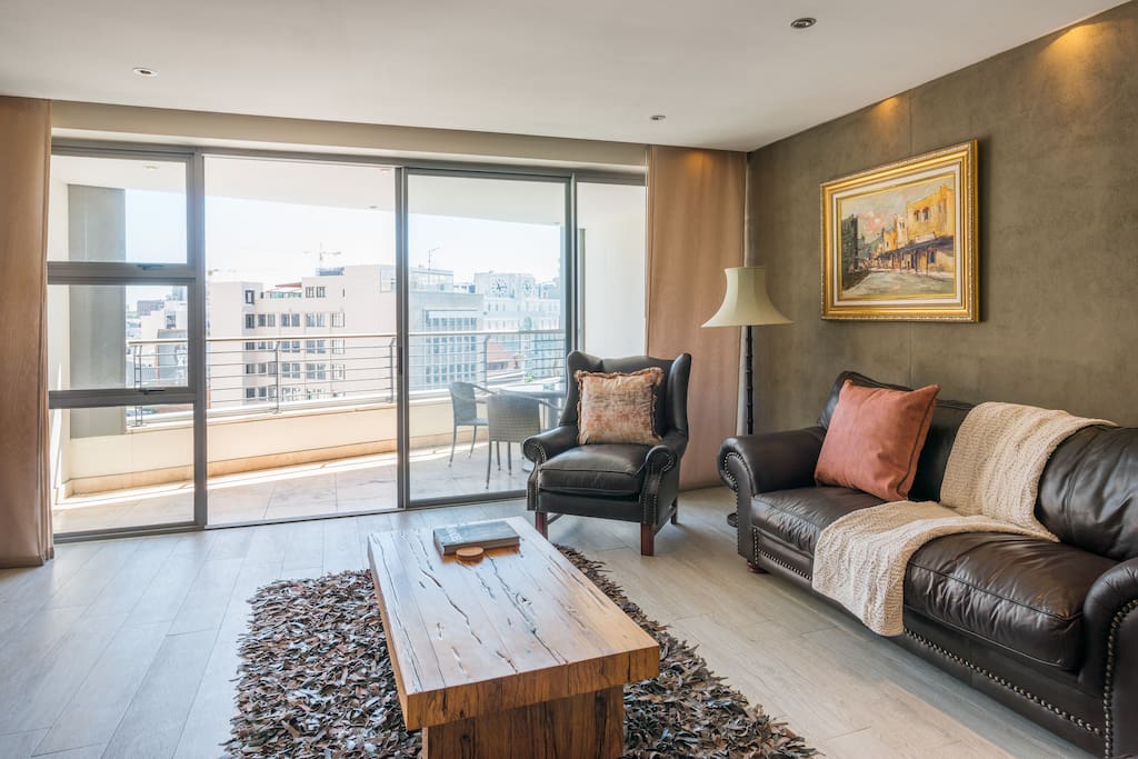 Comfortable living-room that leads onto the large private balcony.