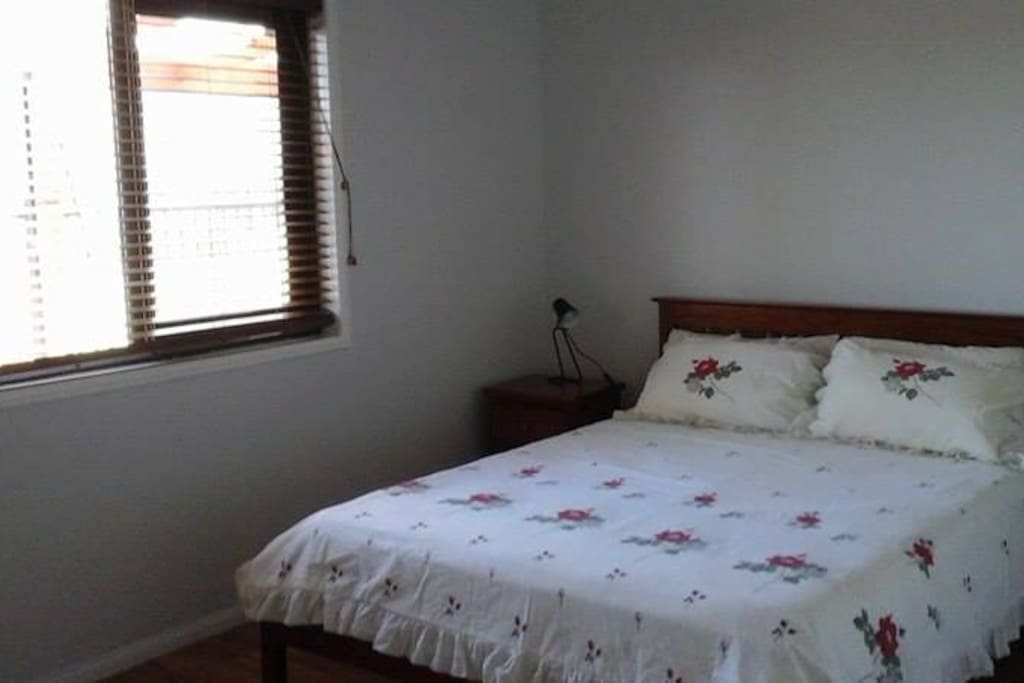 Queen Bedroom with built in robes, bedside tables/drawers, air conditioning and lovely outlook onto parkland next door.